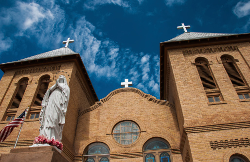 This historic church in La Mesilla, New Mexico is called Basilica of San Albino. The structure was built in 1906 and is now part of the Las Cruces, New Mexico Roman Catholic Diocese.  The building was constructed in Romanesque, French style architecture due to early European influences.