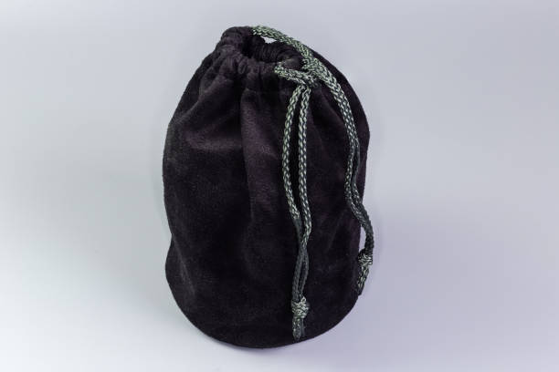istock Small black fabric pouch with rope closure on gray background 1866853780