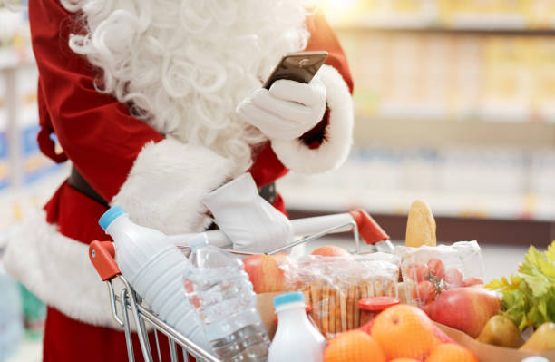 istock Santa Claus using a smartphone at the supermarket 1866854836