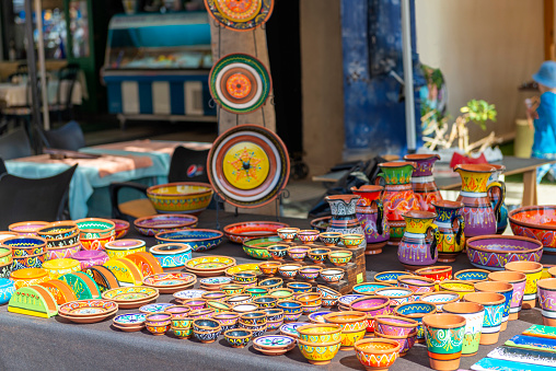 Colorful pottery dishes on market stall - Spanish pottery. Puerto de Mogan, Gran Canaria, Spain.