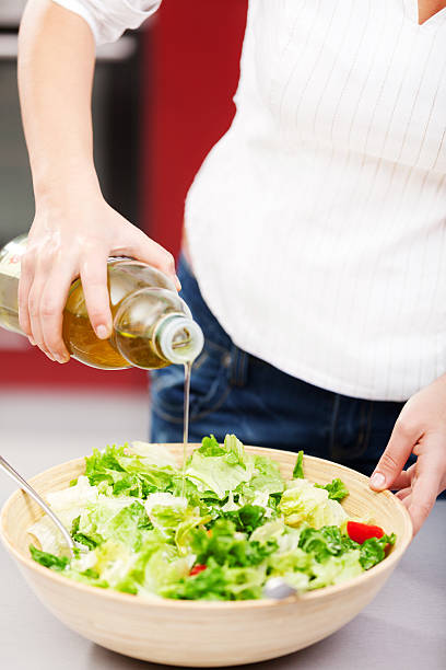 istock Young woman making salad 186687296