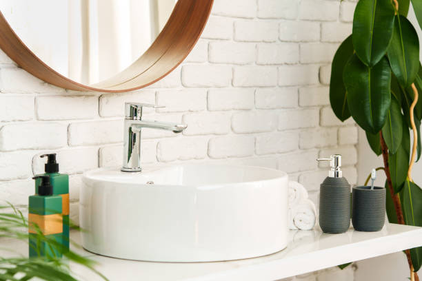 istock Bathroom interior with circle shaped mirror in wooden frame and white sink 1866876524