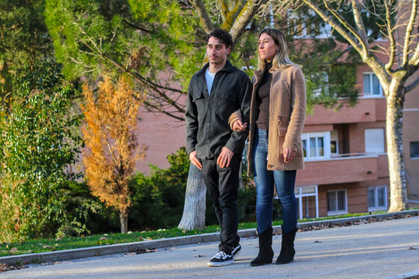 istock Young white couple walking on the sidewalk 1866879152