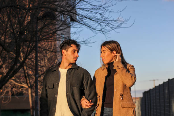 istock Young white couple walking along a city road 1866879183