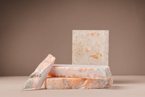istock Piece of granite stone against beige background with shadows 1866882197