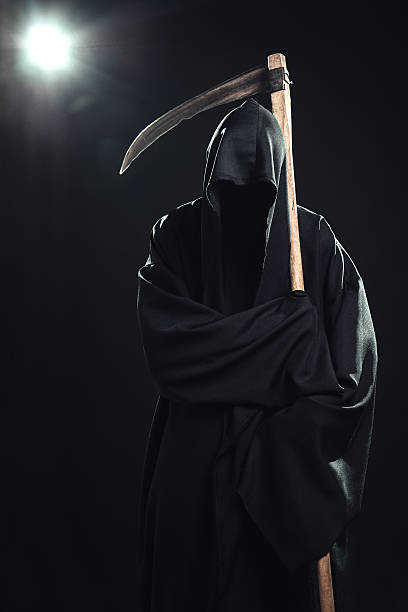 istock death with scythe standing in the dark 186688714