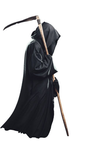 Silhuette of Grim Reaper in sunset on the field. Space for text.