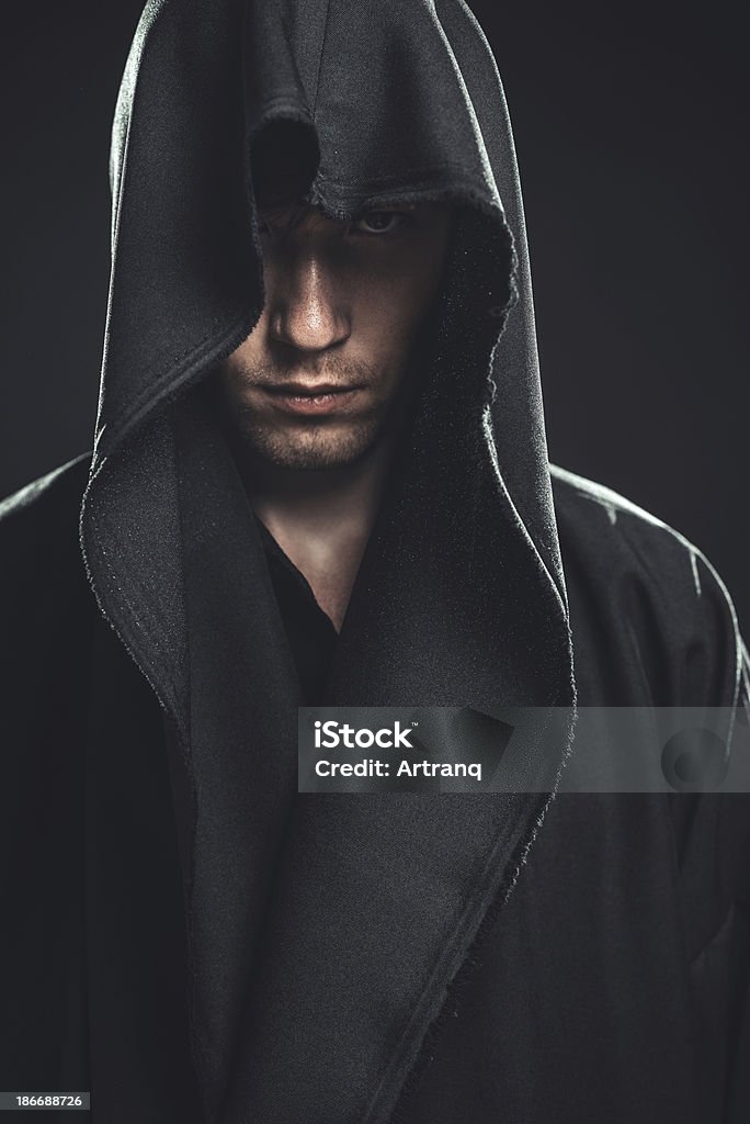 guy in a black robe serious guy in a black robe Adult Stock Photo