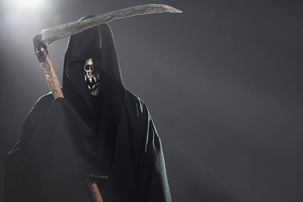 istock death with scythe standing in the dark 186688741