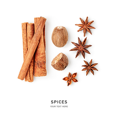 Spice anise stars, nutmeg, cinnamon isolated on background. Decorative spices pattern composition. Creative layout. Healthy eating concept. Flat lay, top view. Design element