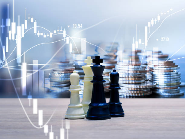 istock Chess pieces and stack of coins money on wooden table. 1866896532