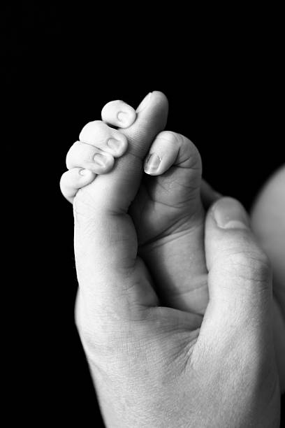 istock Newborn Hand Gripping Father's Finger 186690374