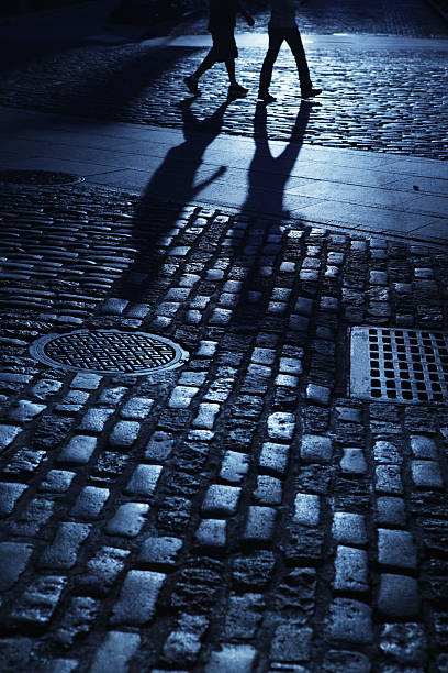 istock Two males walking in blue night shadows 186690612