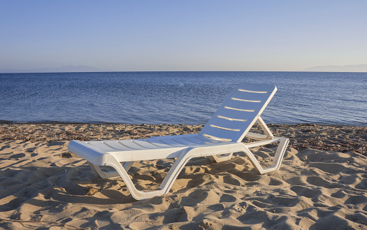 White chaise lounge on a beach