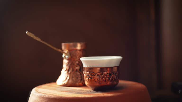 Steamy Turkish Coffee pot known as Cezve or Jezve and coffee cup