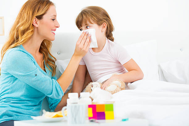 istock Mother Assisting Her Child To Blow Nose. 186690953