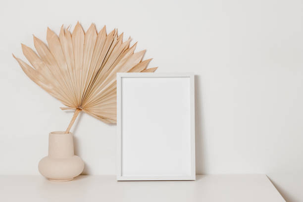 istock Photo frame mockup with palm leaf on the table with copy space. 1866910197