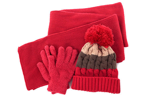 Red and winter hat, scarf and gloves isolated against a white background
