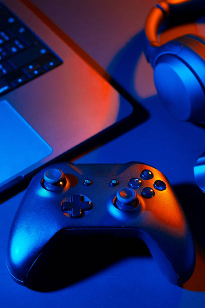 istock Headphones, joystick and computer keyboard on black table 1866915903