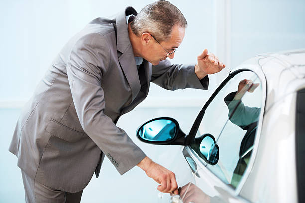istock Businessman looking at the new car. 186692269