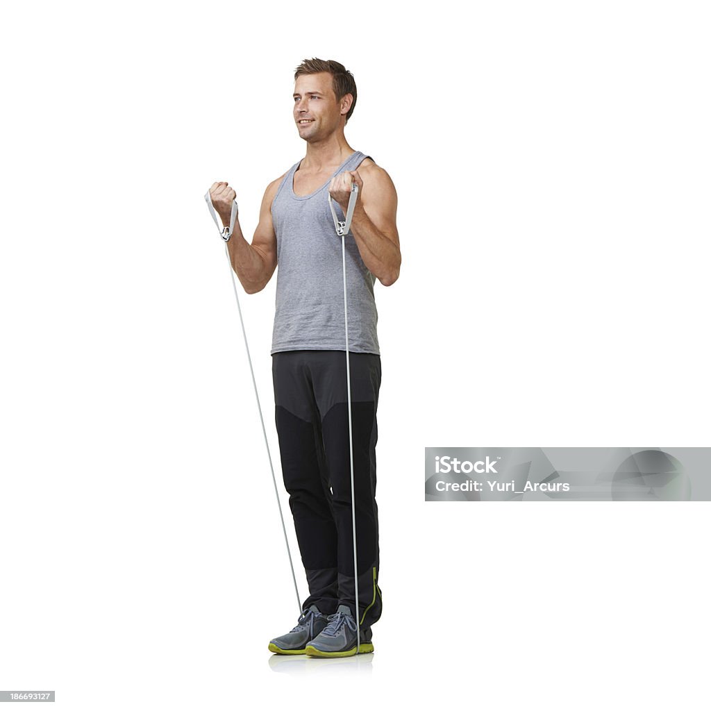 Making progress with every workout! A fit young man working out with a resistance band while isolated on a white background 20-24 Years Stock Photo