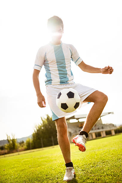 istock Soccer player playing with ball 186693551