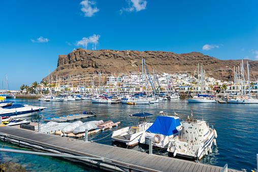 Fishing boats, harbour and colorful houses at the beautiful town of Puerto de Mogan, Gran Canaria