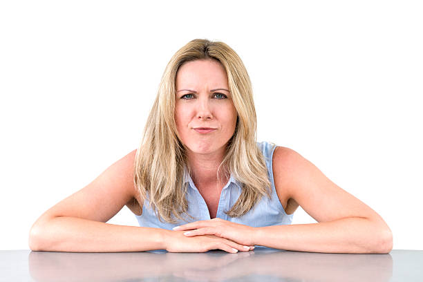 istock offended woman sitting at desk 186695893
