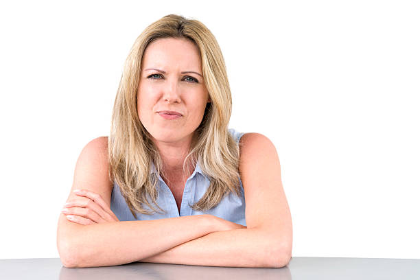 istock offended woman sitting at desk 186696007