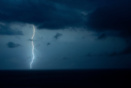A lightning bolt is captured during an electrical storm over the Atlantic Ocean.