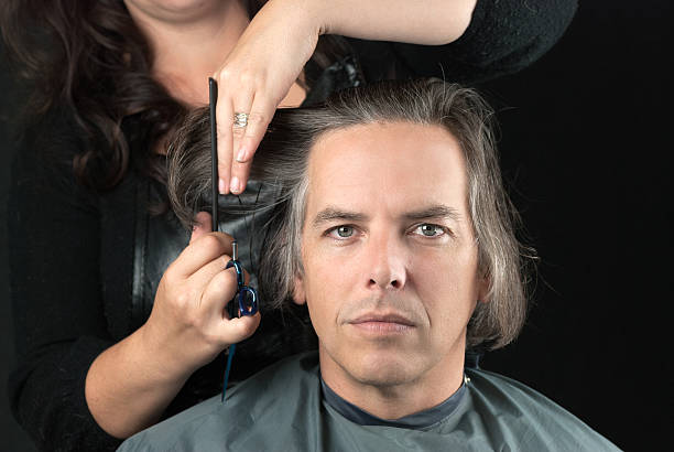 istock Man Getting Long Hair Cut Off For Cancer Fundraiser 186696751