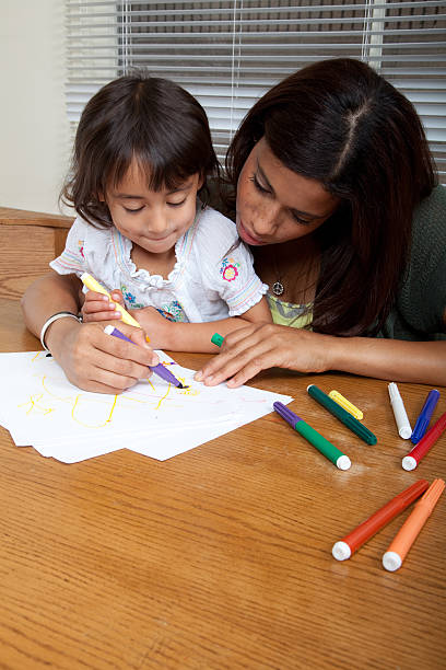 istock Mother and daughter coloring 186697407