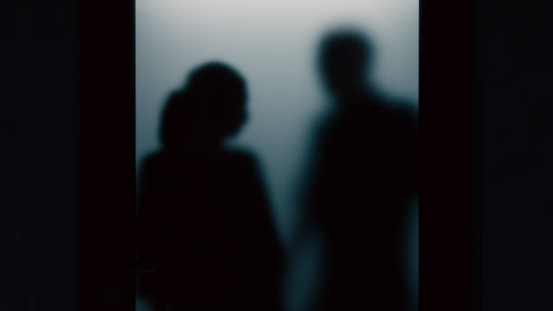 istock A woman is being threatened by a man through opaque glass., 3d rendering 1866974200