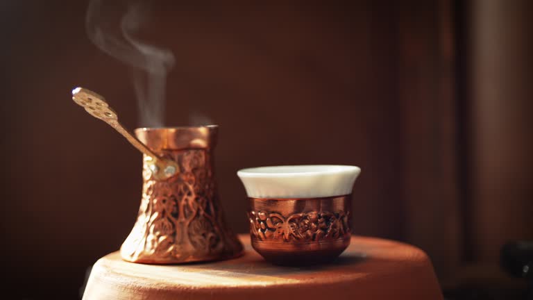 Steamy Turkish Coffee pot known as Cezve or Jezve and coffee cup