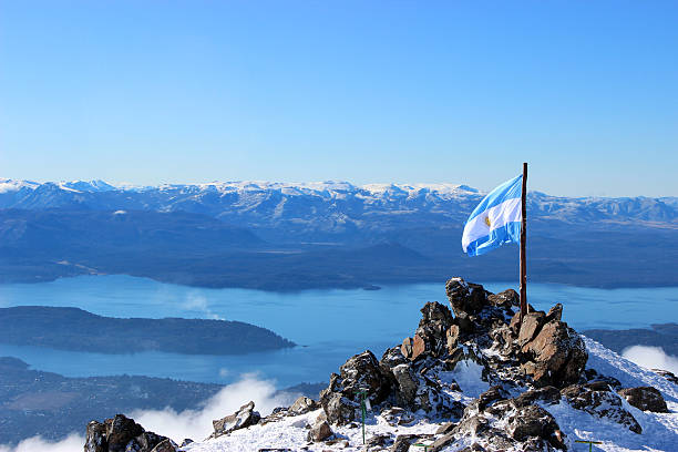 Argentina Flag and Gutierrez lake at background - Andes Patagonia Argentina flag stand at the top of CERRO CATEDRAL MOUNTAIN - in front of Lynch Refuge (Patagonia - Argentina). bariloche stock pictures, royalty-free photos & images