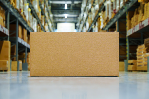 Warehouse, carton box without text on floor for transportation and logistics purposes. Idea and logistics concept. Blank paper cardboard box mockup on the floor, Packaging template.