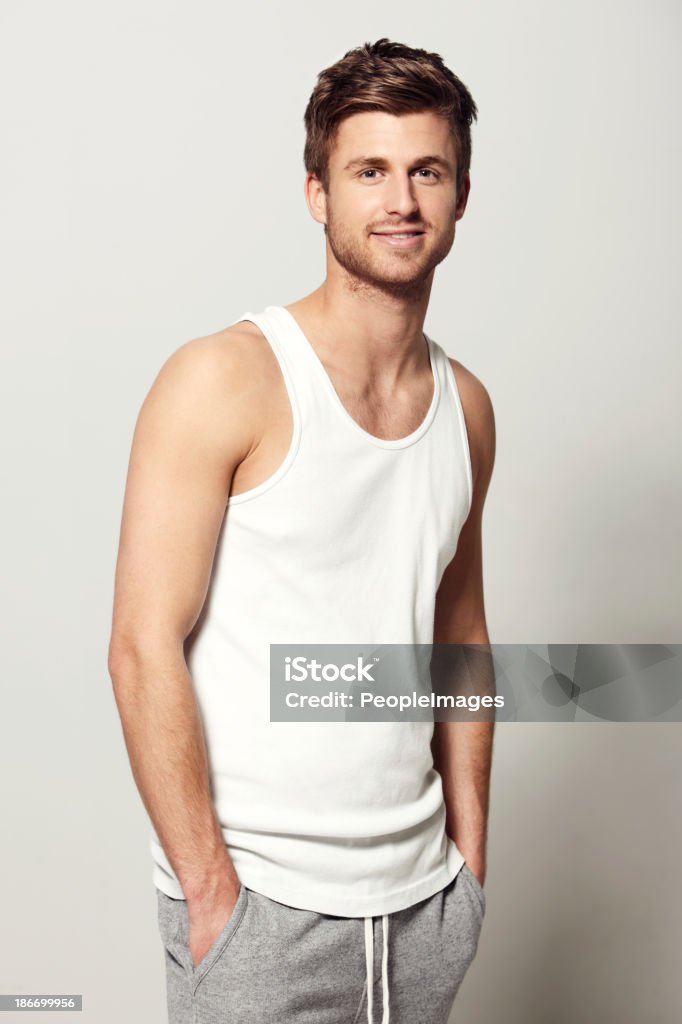 I make everything look cool! Studio portrait of a casually dressed young man smiling at the camera Tank Top Stock Photo