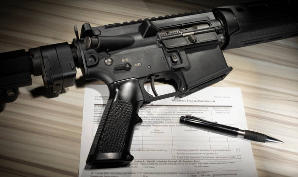 istock AR15 with public domain background check form from FBI 1867002115