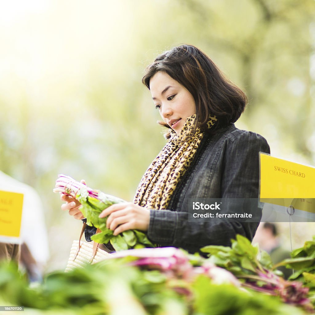 Chinese Woman in Farmers Market Chinese Woman shopping fresh ingredients in Farmers Market Agricultural Fair Stock Photo