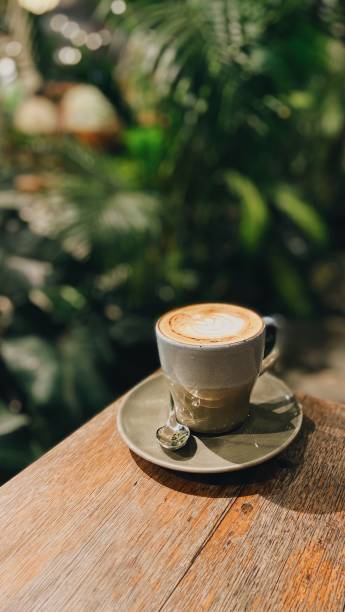 istock A glass of cappuccino with tropical background 1867014637