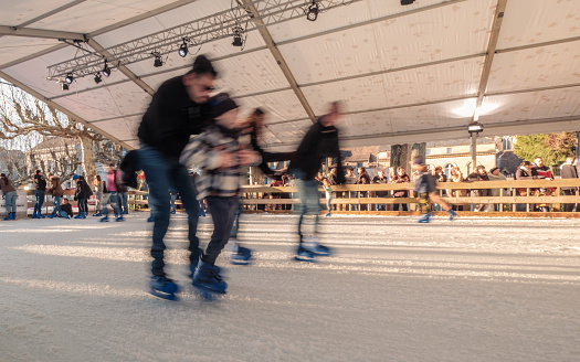 Sarlat-la-CanÃ©da, Nouvelle-Aquitaine, France - 16th December 2023: Skaters on the ice rink at the Sarlat-la-CanÃ©da Christmas market in the Dordogne region of France