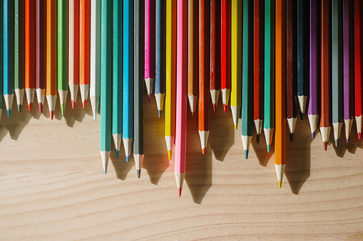 A large variety of wooden colored pencils in vibrant colors