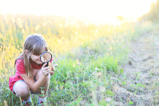 istock Little girl with magnifying glass 186704785
