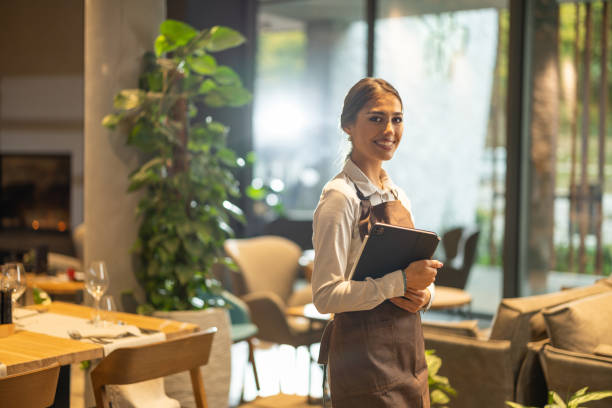 istock Beautiful waitress in restaurant 1867049502
