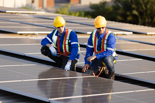 Two engineer checking solar panel on rooftop