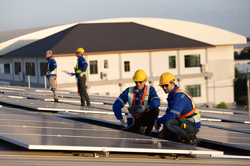 Group engineer on rooftop install solar panel