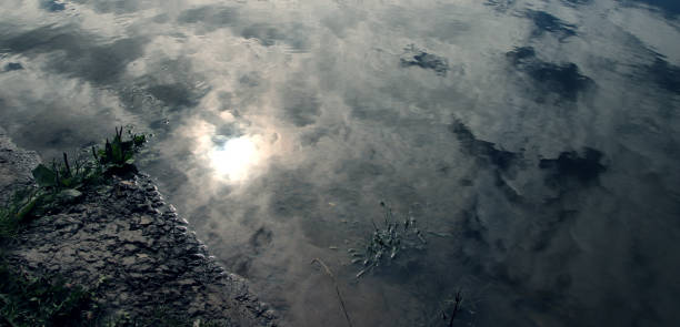 istock The Mysterious Shore. Reflection of cloudy sky in the river. 1867067674