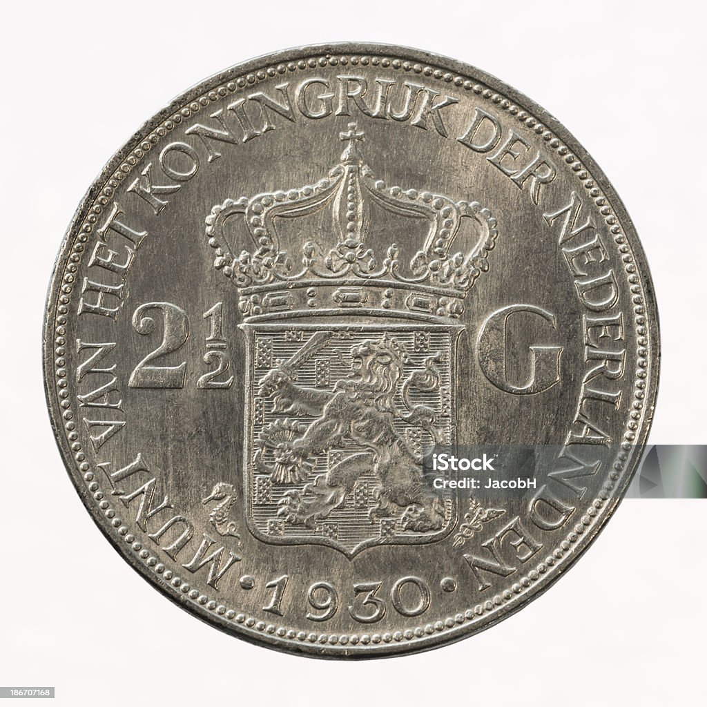 Dutch Silver Coin Close-up of a Dutch silver two-and-a-half guilder coin ("rijksdaalder"), isolated on white. This coin was issued in 1930 under the queenhood of Queen Wilhelmina.  Dutch Guilders Stock Photo