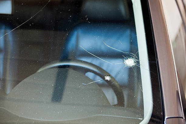 Cracked Windshield Huge rock chip in windshield. peeling off stock pictures, royalty-free photos & images