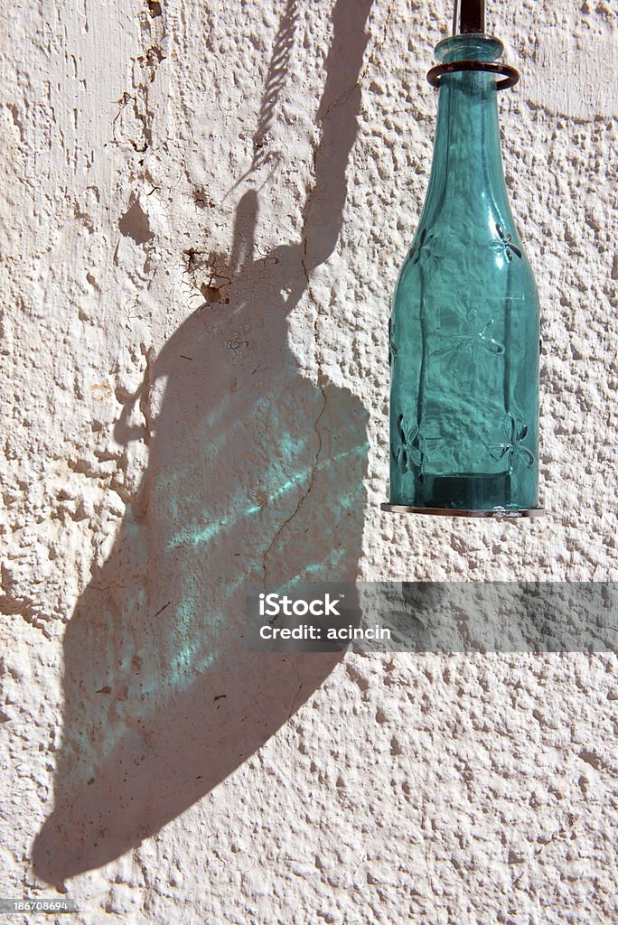 Bottle and Shadow Bottle on the Wall and colour shadow. Bottle Stock Photo